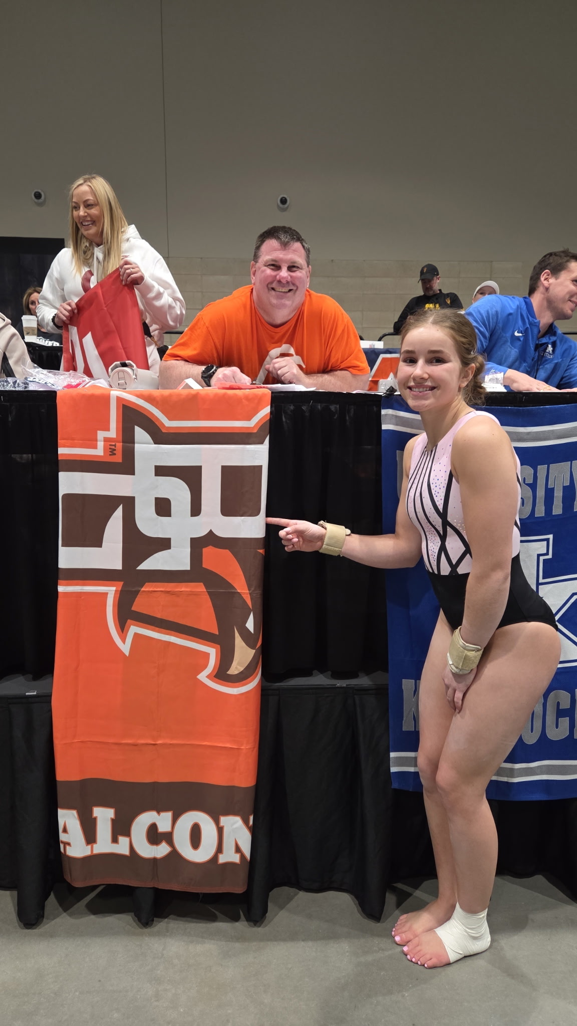 Gymnasts with their coaches at a competition